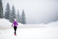 Trail running woman in winter mountains Royalty Free Stock Photo