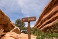 Trail sign between sandstone cliffs