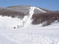 Trail to cross-country skiing.Fresh snow groomer tracks on a ski piste. cable car in the snow Royalty Free Stock Photo