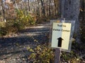 Trail to visitor sign with trail in woods Royalty Free Stock Photo