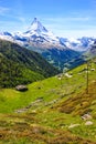 Trail with view of traditional village with the iconic Matterhorn Peak background in summer day, Zermatt, Switzerland, Europe Royalty Free Stock Photo