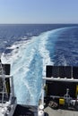 Water trail foaming behind a ferry boat in Mediterranean sea