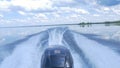 Trail on water surface behind of fast moving motor boat. the motor of motor boat, back view. Sea water ship trail with Royalty Free Stock Photo