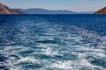 Trail on water surface or powerful stern wave behind of fast moving speedboat or ferry while cruising on ocean. Greek Aegean Royalty Free Stock Photo