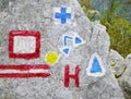 Trailblazing signs on a rock in Cernei Mountains.