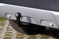 Trailer coupling on a silver-coloured car with reverse warning devices