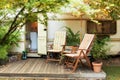 Two deckchairs near outside caravan trailer. Cozy Campsite on caravan or camper van in forest. Royalty Free Stock Photo