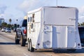 Trailer transporting horses towed by a semi-truck on the freeway