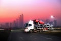 The trailer transports cars on highway