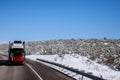 The trailer transports cars on highway winter road with snow landscape