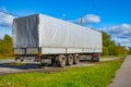 The trailer from the truck stands against the blue sky