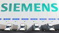 Electric semi-trailer trucks at warehouse loading bay with SIEMENS logo on the wall. Editorial 3D rendering Royalty Free Stock Photo