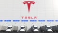 Electric semi-trailer trucks at warehouse loading bay with TESLA logo on the wall. Editorial 3D rendering Royalty Free Stock Photo