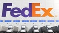 Electric semi-trailer trucks at warehouse loading bay with FEDEX logo on the wall. Editorial 3D rendering Royalty Free Stock Photo