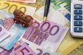 Train above euro banknotes with pen