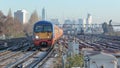 Train Approaches the Camera with London Skyline Behind Royalty Free Stock Photo