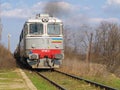 A train approaching and smoking, on the railway lines Royalty Free Stock Photo