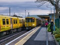 A train arrives as another train waits on Hoylake Station on the Merseyrail electric rail transport network