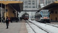 The train arrives at the passenger platform in Minsk on a winter day