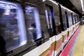 The subway train in motion arriving the train station.