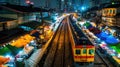 Train arriving at night at a vibrant street station with local market stalls