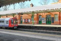 Train arriving on the platform of Barkingside Underground station. Royalty Free Stock Photo
