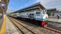 Train with Blue Stripe Livery Under Blue Sky Royalty Free Stock Photo