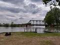 Train bridge Fishing village Boats marina View Water sky clouds lake sea