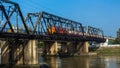 The train on the bridge runs across the river.