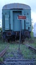 Train car at a dead end of a railway track and an empty sign on rails Royalty Free Stock Photo