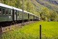 Train carriages of the Flamsbana Flam Line running through a green valley. Flam railway is a railway line between Myrdal and Fl Royalty Free Stock Photo