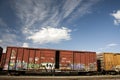 Train Cars with Graffiti Against a Blue Sky Royalty Free Stock Photo