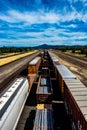 Train cars vertical down a track overlooking mountain range. Royalty Free Stock Photo