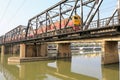 A train come across Chulalongkorn railway bridge at Ratchaburi, Thailand