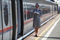 The train conductor waiting for the passengers of the high speed electric train Sapsan. Moscow, Russia