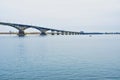 A train crossing a bridge over a body of water Royalty Free Stock Photo