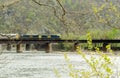 Train crossing river bridge