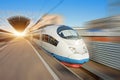 The train departs from the platform of the passenger station, traveling at high speed through the city Royalty Free Stock Photo