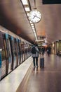 Train with doors open and a passenger with bag heading for the stations exit Royalty Free Stock Photo