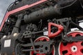 Train drive mechanism and red wheels of an old soviet steam locomotive Royalty Free Stock Photo