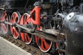 Train drive mechanism and red wheels of an old steam locomotive Royalty Free Stock Photo