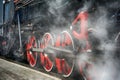 Train drive mechanism and red wheels of an old steam locomotive Royalty Free Stock Photo