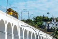 Train drives along distinctive white arches of the landmark Lapa Arches in Rio de Janeiro, Brazil