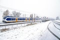 Train driving in a snowstorm in the Netherlands Royalty Free Stock Photo