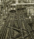 Train on elevated tracks within buildings at the Loop, Chicago City Center - Black Gold BW Artistic Effect