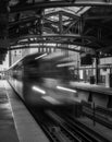 Train on elevated tracks within buildings at the Loop, Chicago City Center - Black and White with Long Exposure Artistic Effect - Royalty Free Stock Photo