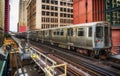 Train on elevated tracks within buildings at the Loop, Chicago City Center - Warm Sunset Artistic Effect - Chicago, Illinois Royalty Free Stock Photo