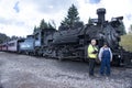 Train engineer and worker getting ready to take the Cumbres & Toltec steam engine historic train over the Cumbres Pass in Colorado Royalty Free Stock Photo