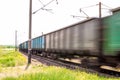 Train with freight wagons in motion on electrified railway Royalty Free Stock Photo