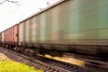 Train with freight wagons in motion on electrified railway Royalty Free Stock Photo